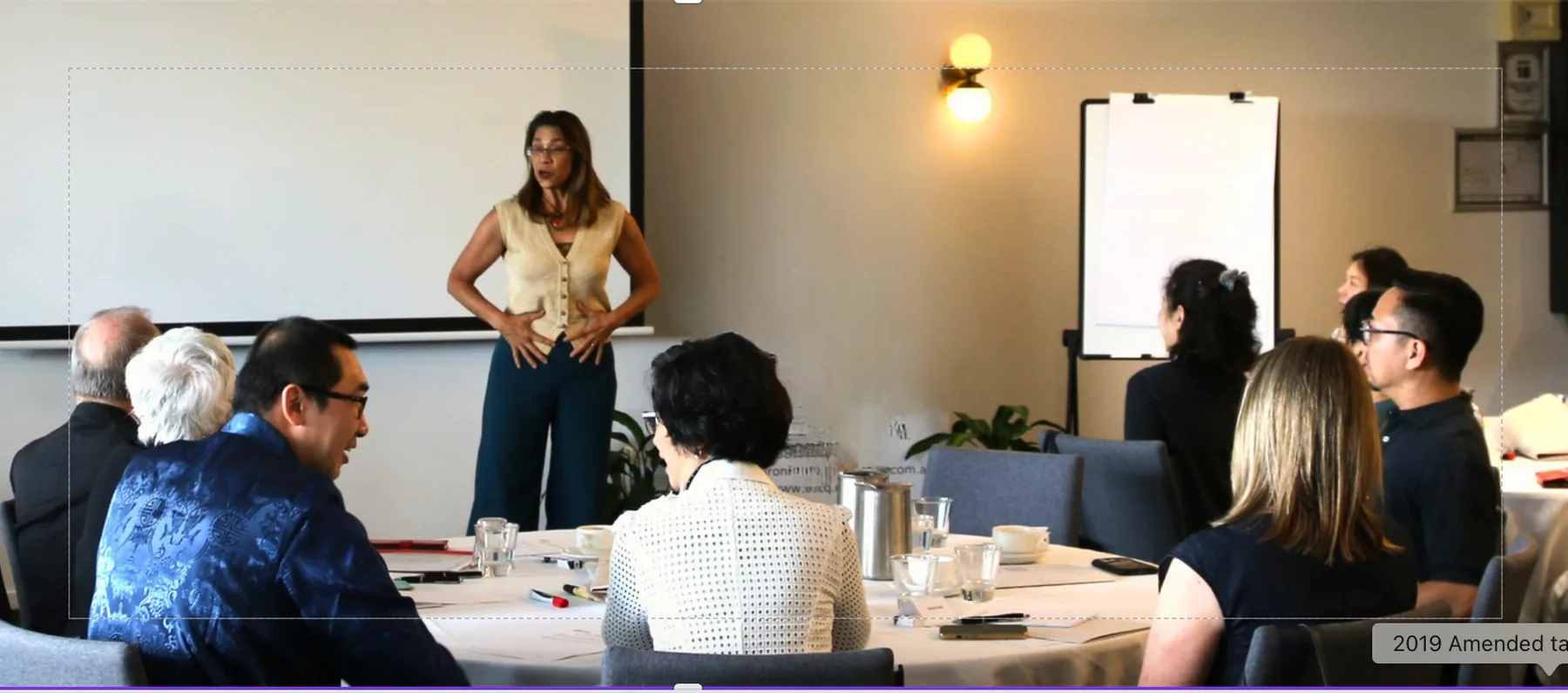 Dara facilitating a workplace wellbeing session with a professional audience